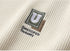 Embroidered U logo patch detail in olive and white