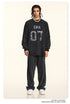 Full-length view of black 'ERA 07' sweatsuit with relaxed fit