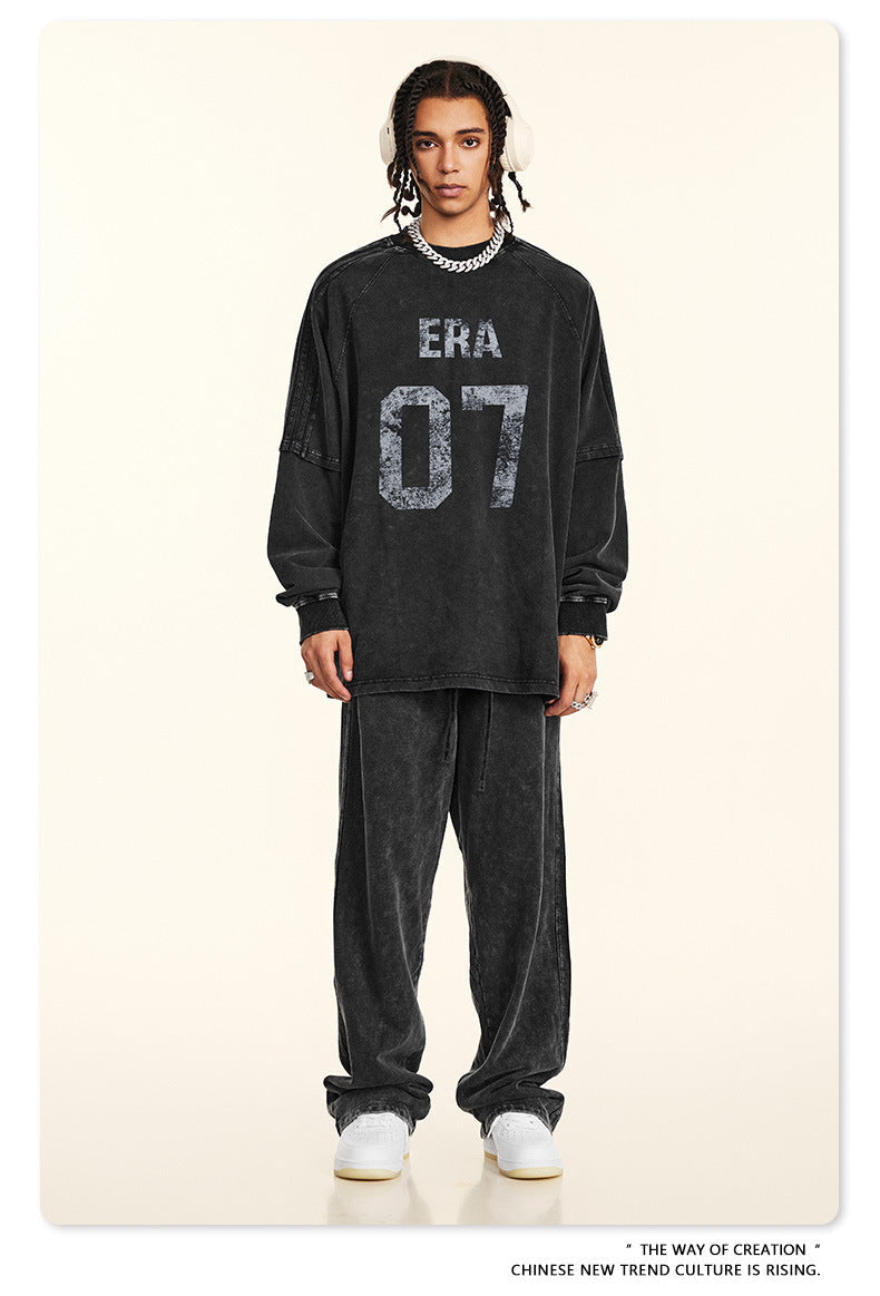 Full-length view of black 'ERA 07' sweatsuit with relaxed fit