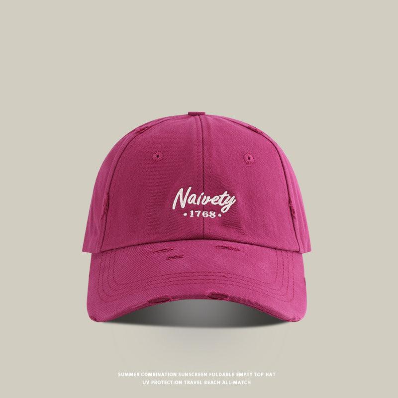 Magenta baseball cap with white 'Naivety 1768' embroidered logo