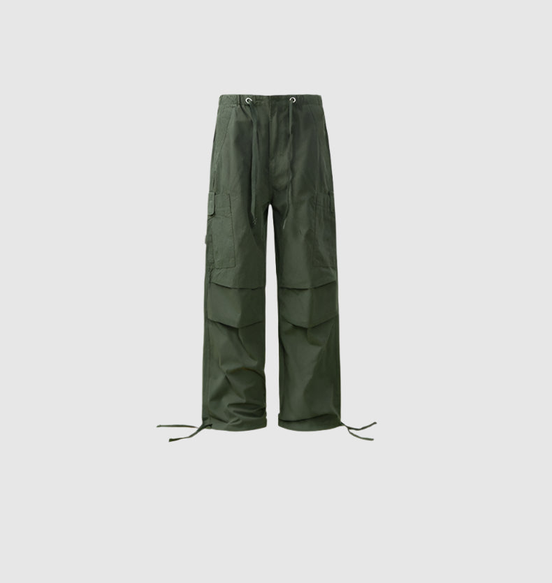 Olive green drawstring cargo pants with tiered panel design and multiple pockets displayed on light gray background
