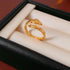 Gold snake ring with textured pattern in jewelry box