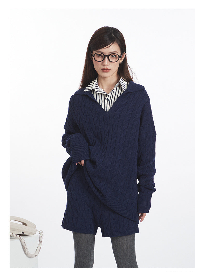 Navy cable knit set: Oversized V-neck sweater styled over striped shirt, paired with matching knit shorts in same cable pattern. Preppy academic styling.