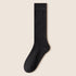 Single black knee-high sock displayed flat showing full length and cuff detail