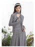 Gray jersey dress with ruched bodice design, attached neck scarf, and flowing maxi skirt