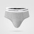 Light gray men's brief underwear with branded elastic waistband reading "UNDERWEAR", displayed floating against neutral background