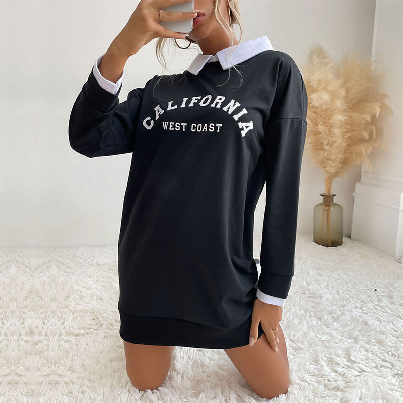 Side view of black collegiate sweatshirt dress with decorative pampas grass styling