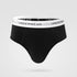 Black men's brief underwear with white elastic waistband featuring "UNDERWEAR" text logo, photographed against light gray background