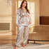 Light silver satin pajama set with delicate floral print, featuring a wrap-style top with tie waist and matching wide-leg pants