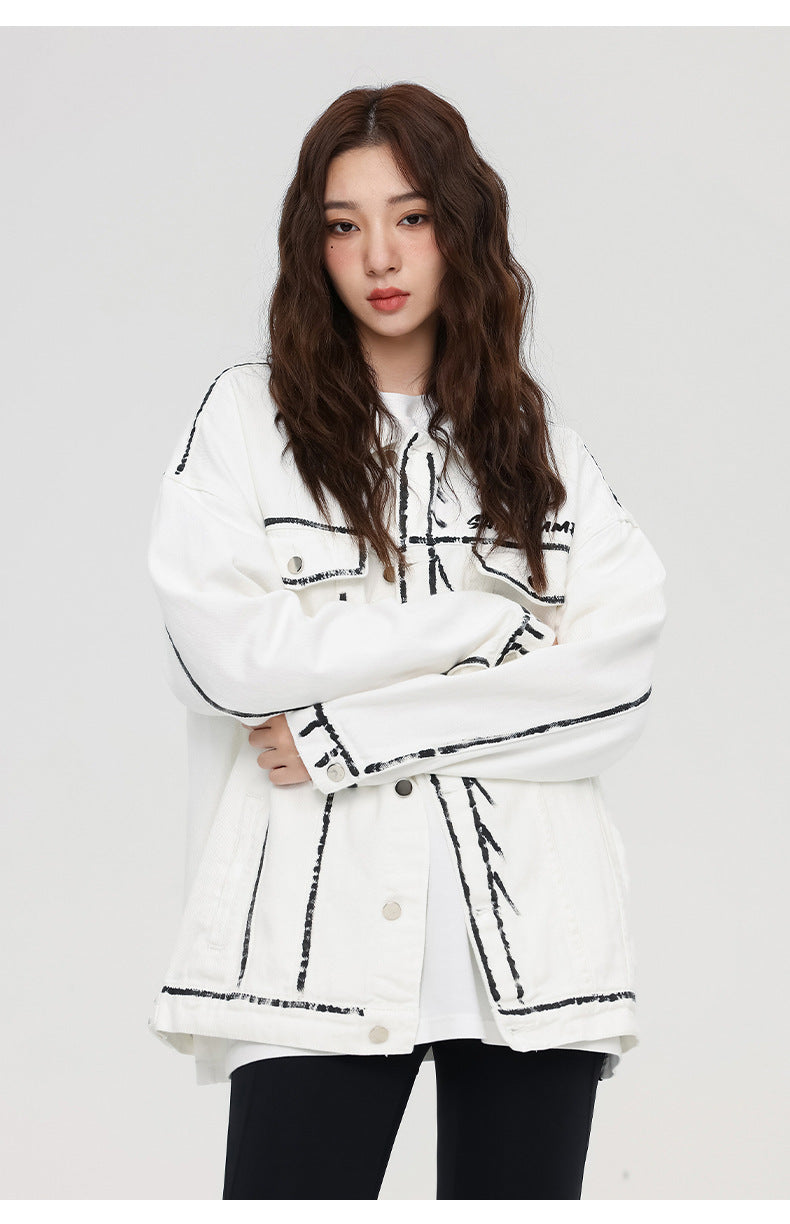 A woman is standing with arms crossed wearing a white SANHOMME outline denim jacket, white tee, and black pants against gray background