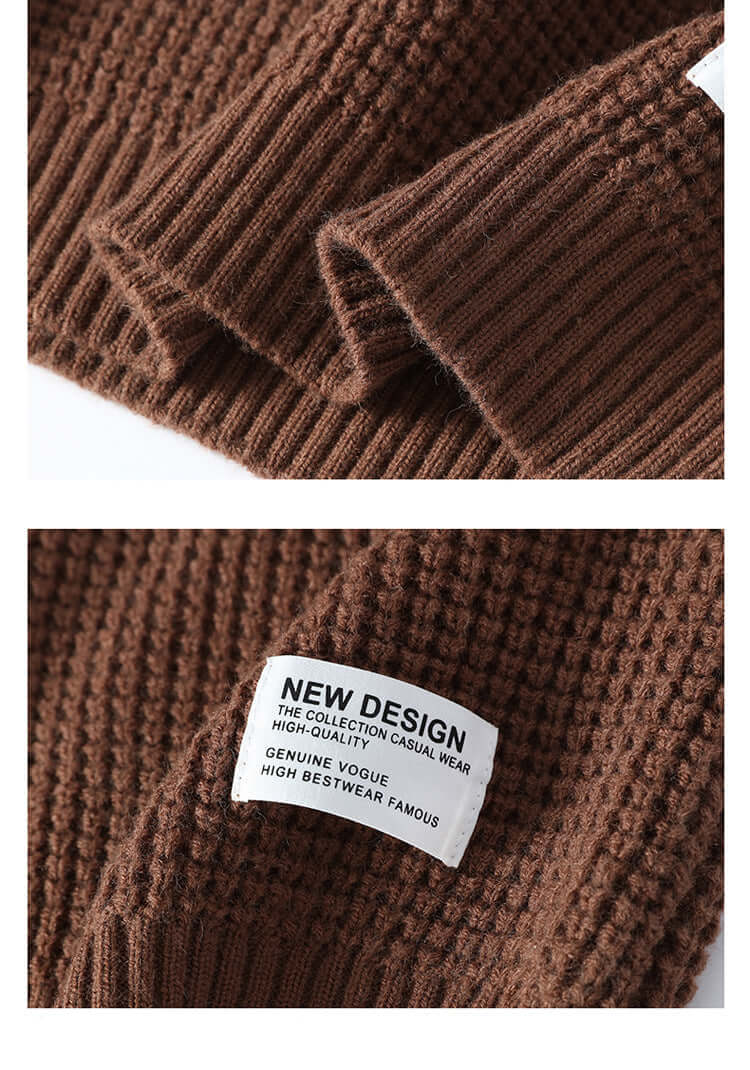 Close-up detail of brown ribbed knit fabric with folded edge and white 'NEW DESIGN' clothing label against textured knit background