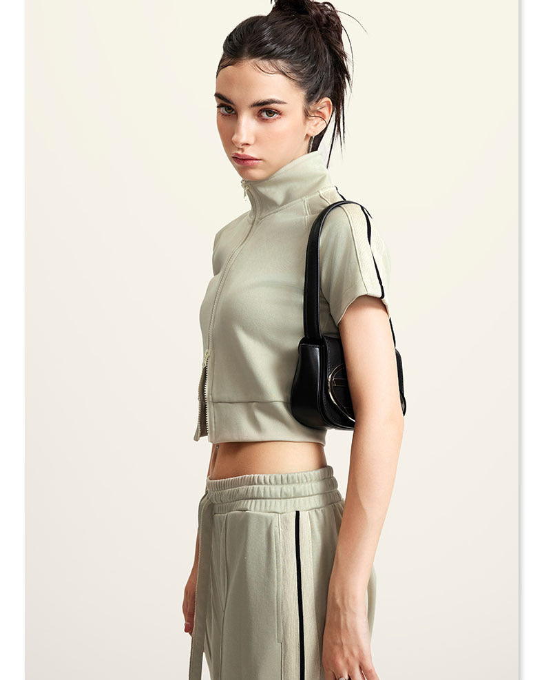 Olive green mock neck crop top with front zip and white sleeve stripes, side view