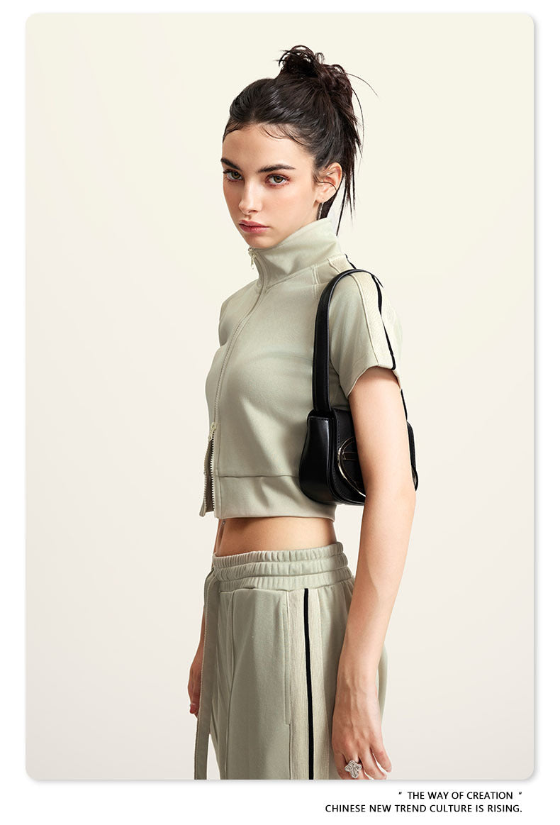 Olive green mock neck crop top with front zip and white sleeve stripes, side view