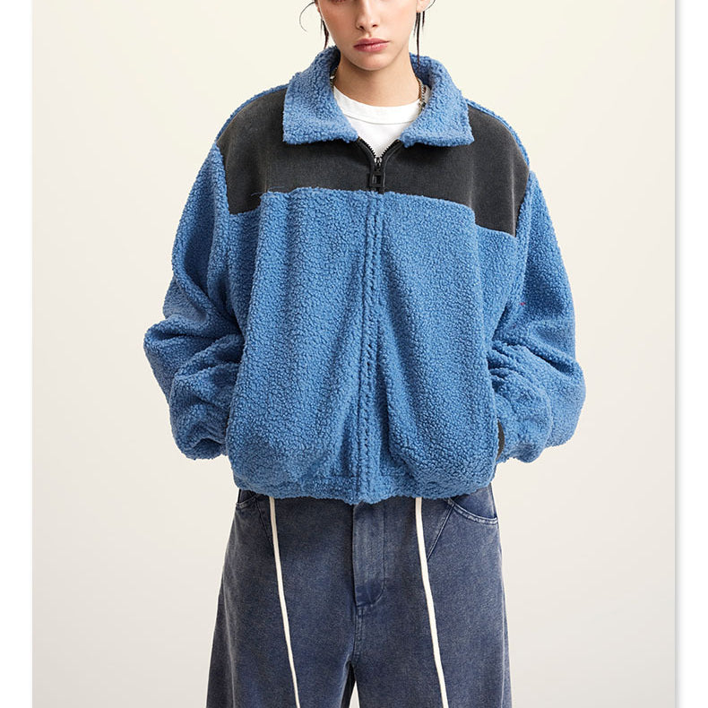 Blue fleece jacket with black color-block shoulders and full zip
