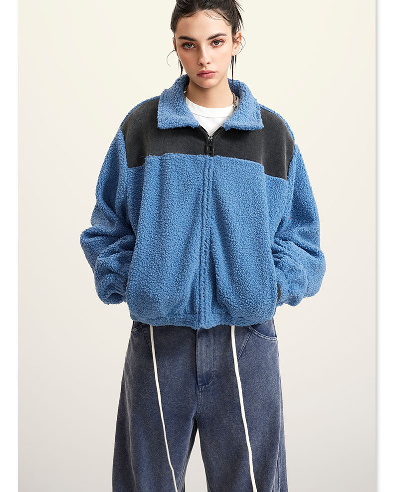 Blue fleece jacket with black color-block shoulders and full zip