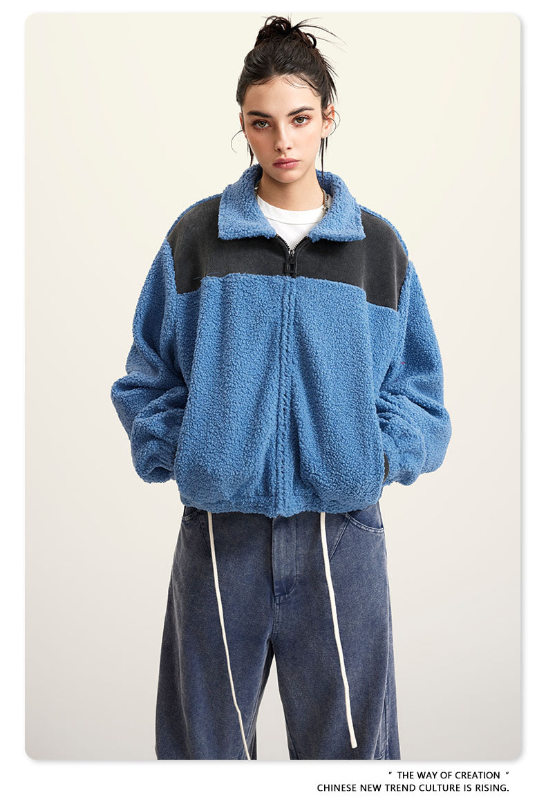 Blue fleece jacket with black color-block shoulders and full zip