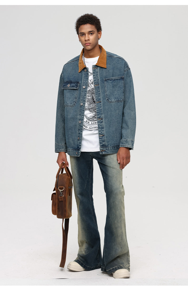Man wearing denim jacket with brown corduroy collar over white graphic tee and light wash jeans holding brown bag