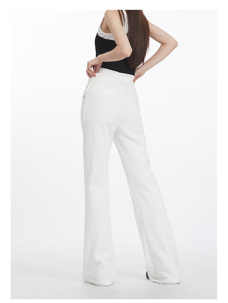 White flared pants shown from back view, featuring back pockets