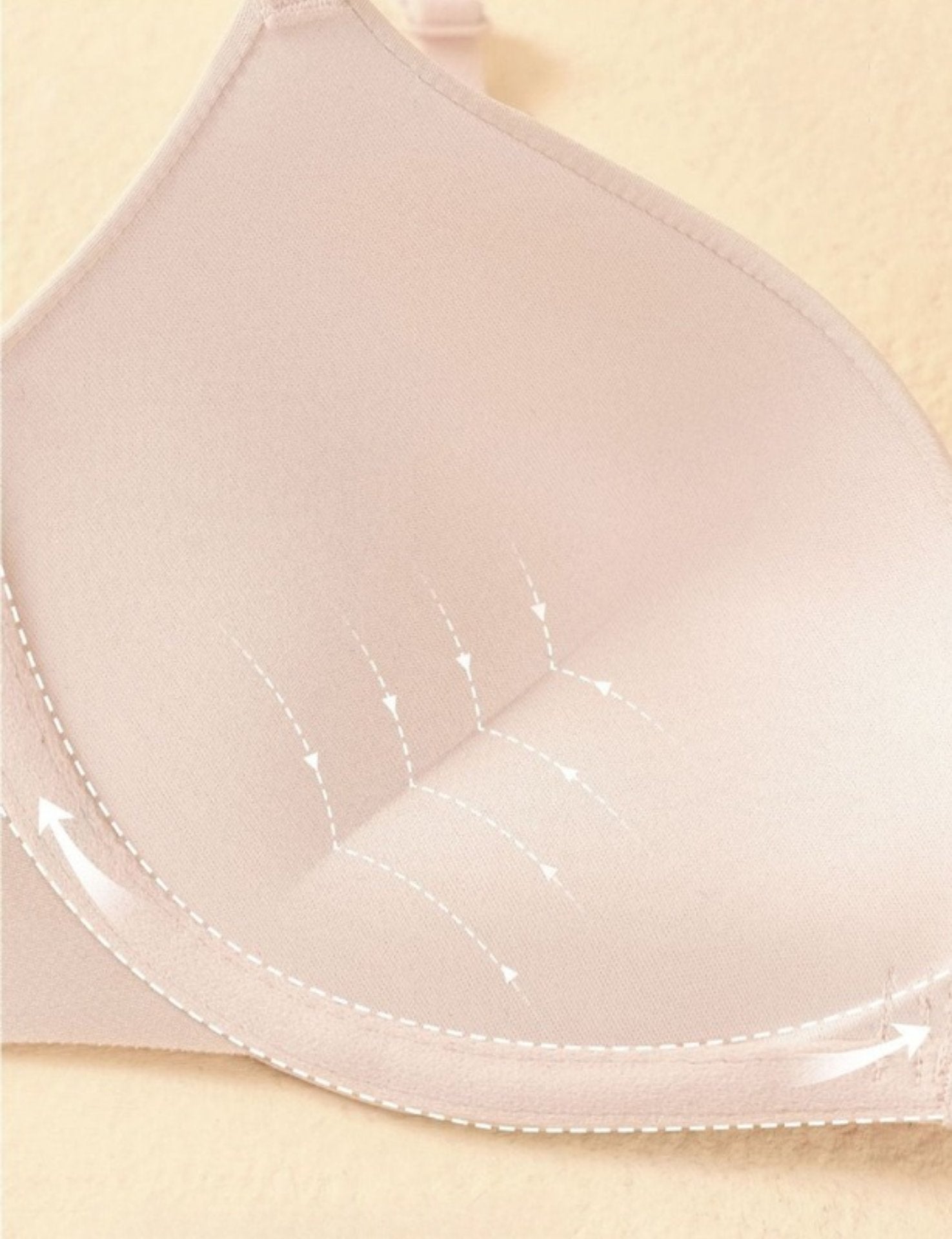 Close-up of thickened lower cup padding designed to lift and enhance bust shape.