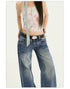 Flat lay close-ups of waistband, hem and fabric texture of Y2K wide leg jeans