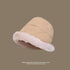 Beige bucket hat with cream faux fur trim, angled view showing plush lining, foldable sunscreen design, taupe background