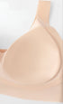 Close-up of a beige seamless bra highlighting the fixed cup padding.