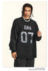 Close-up of black 'ERA 07' sweatshirt front with silver chain accessory