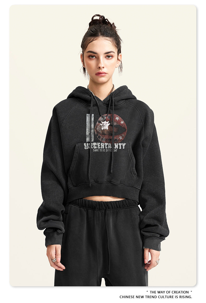 Black cropped hoodie with graphic print, straight front view
