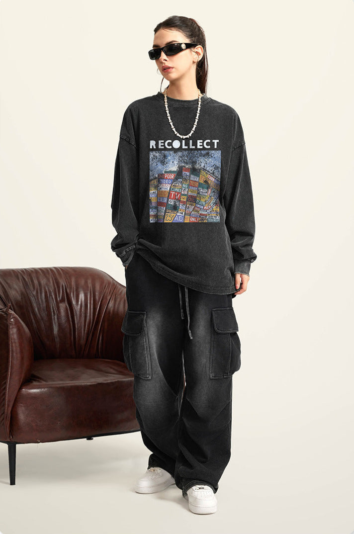 A female model wears a black oversized "RECOLLECT" sweatshirt, black pants, and sunglasses, standing confidently