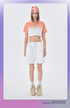 Coral and white ombré cropped t-shirt, white shorts, red tie-dye beanie, with silver chain necklace