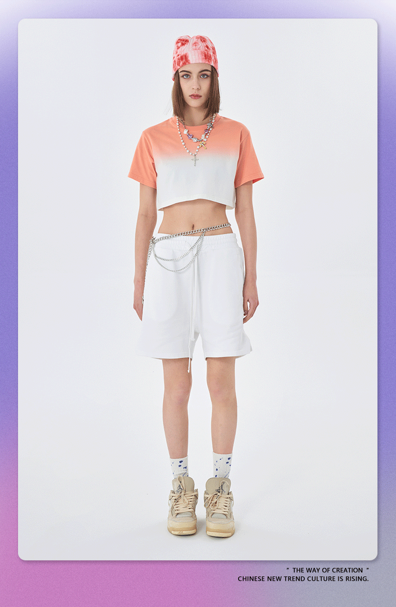 Coral and white ombré cropped t-shirt, white shorts, red tie-dye beanie, with silver chain necklace