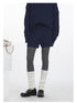 Lower body detail showing navy knit shorts styled with grey tights and white leg warmers.