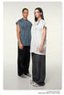 Two models in gray and white t-shirts with dark pants standing side by side against cream background