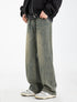 A model standing in olive-green wide-leg jeans with faded wash effect, black bomber jacket, hand in pocket, wearing gray and white athletic shoes