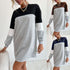 Color-block sweatshirt dress in gray, black, white. Gold chain necklace, curly hair