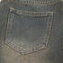 Back pocket detail of washed gray wide-leg jeans with traditional stitching pattern