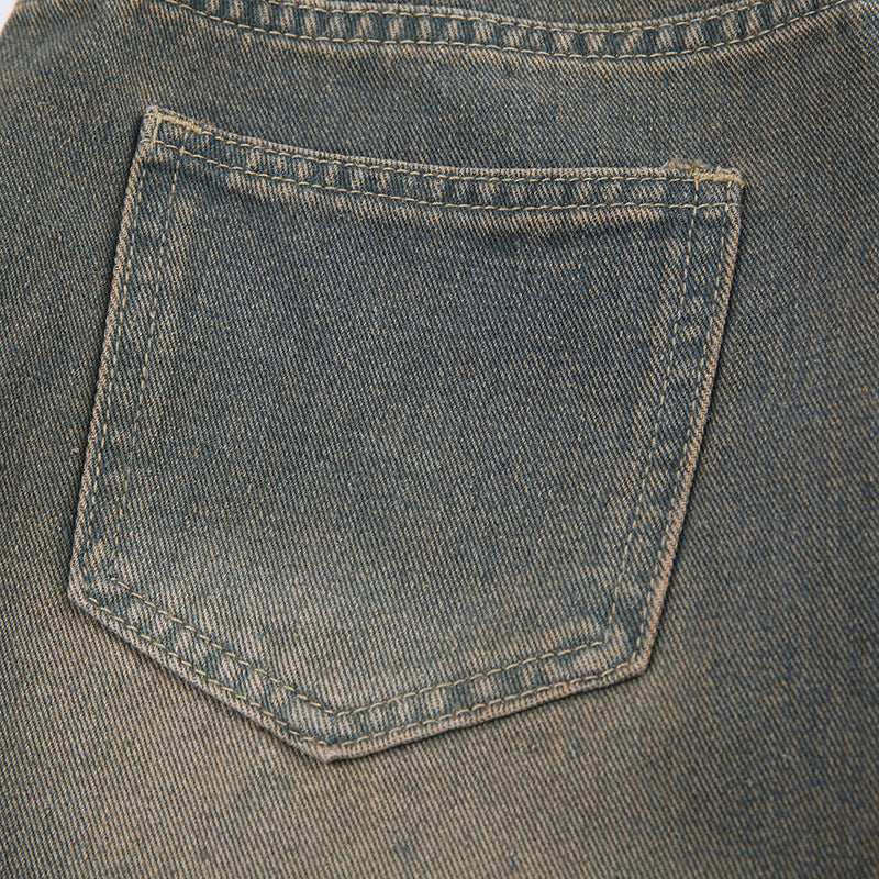 Back pocket detail of washed gray wide-leg jeans with traditional stitching pattern