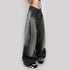 Side angle of gray wide-leg jeans with vintage wash, paired with black and white platform sneakers on white background
