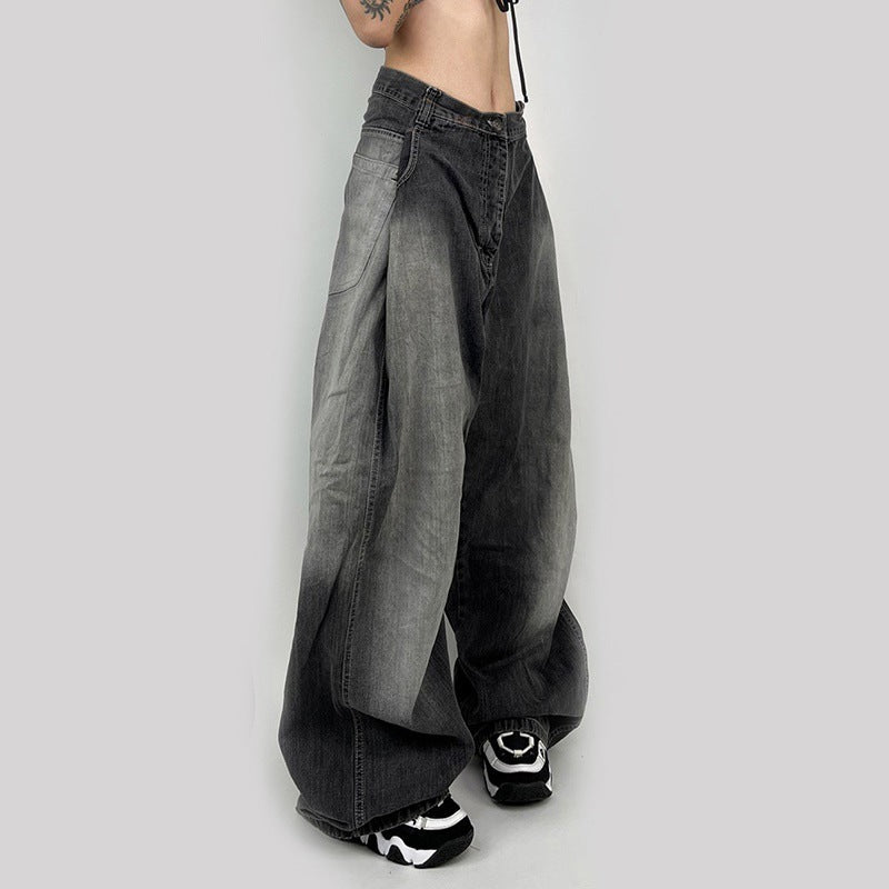 Side angle of gray wide-leg jeans with vintage wash, paired with black and white platform sneakers on white background