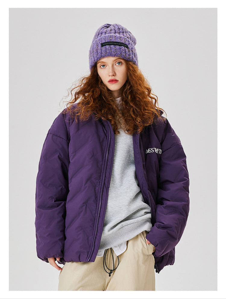 Woman with curly red hair wearing purple Aesthetic puffer jacket paired with matching knit beanie and khaki pants