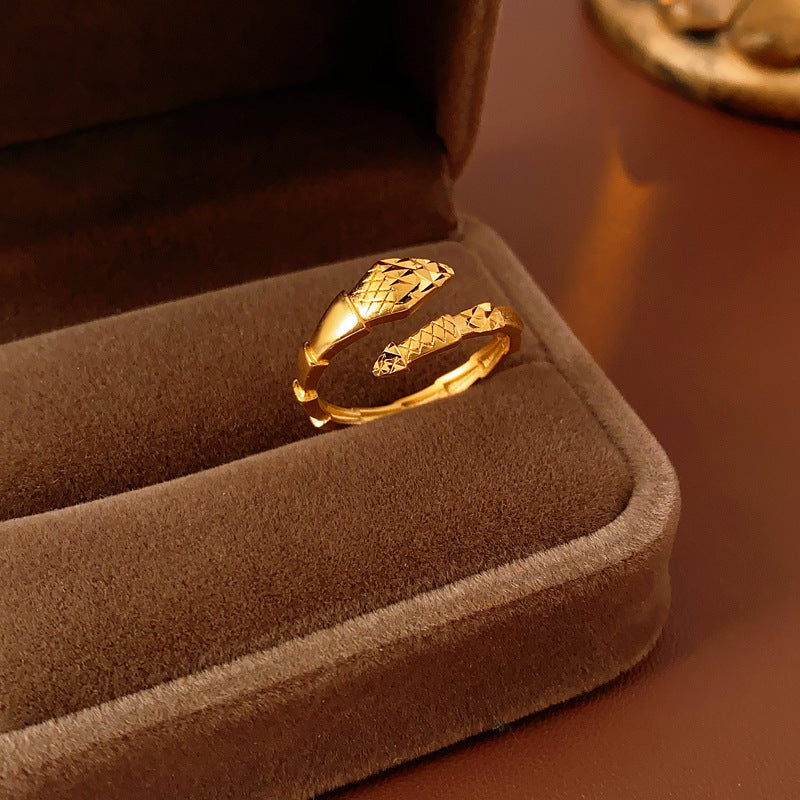 Detailed view of gold snake ring showing scale texture