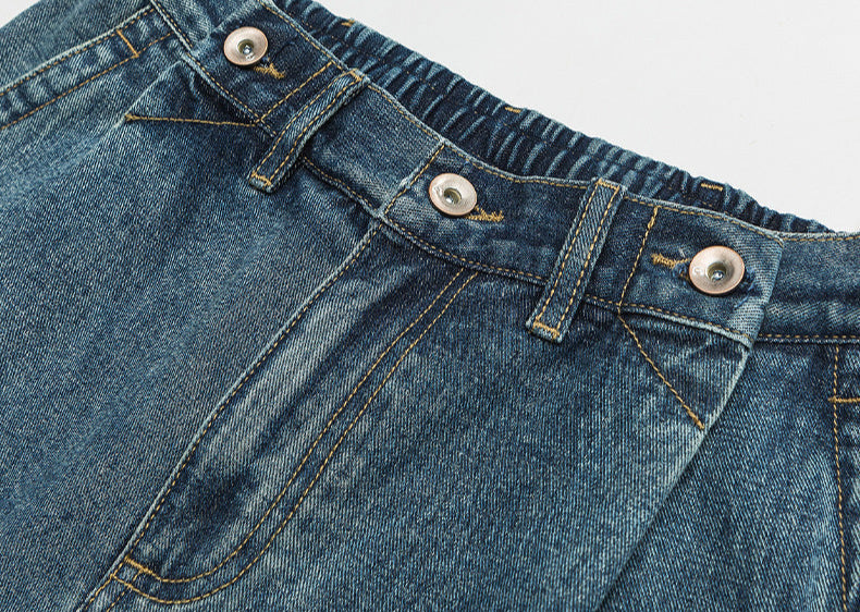 Detail shot of denim construction showing stitching and seam details on wide-leg jeans