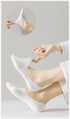 Demonstration of white no-show socks' stretch and fit features with pull-test detail