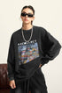 A female model wears a black "RECOLLECT" sweatshirt with a graphic print, cargo pants, and sunglasses, posing against a neutral backdrop