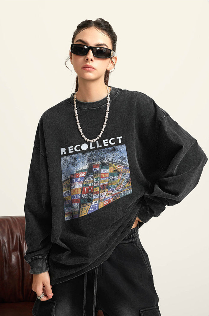 A female model wears a black "RECOLLECT" sweatshirt with a graphic print, cargo pants, and sunglasses, posing against a neutral backdrop