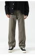 Olive green wide-leg pants with relaxed fit, paired with black top and white platform sneakers
