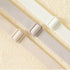 Close-up of three adjustable elastic bra straps in white, nude, and silver, designed for comfort and stability.