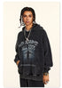 Model with braided hair wearing black "Win Against All Odds" graphic hoodie, standing in studio with chain necklace