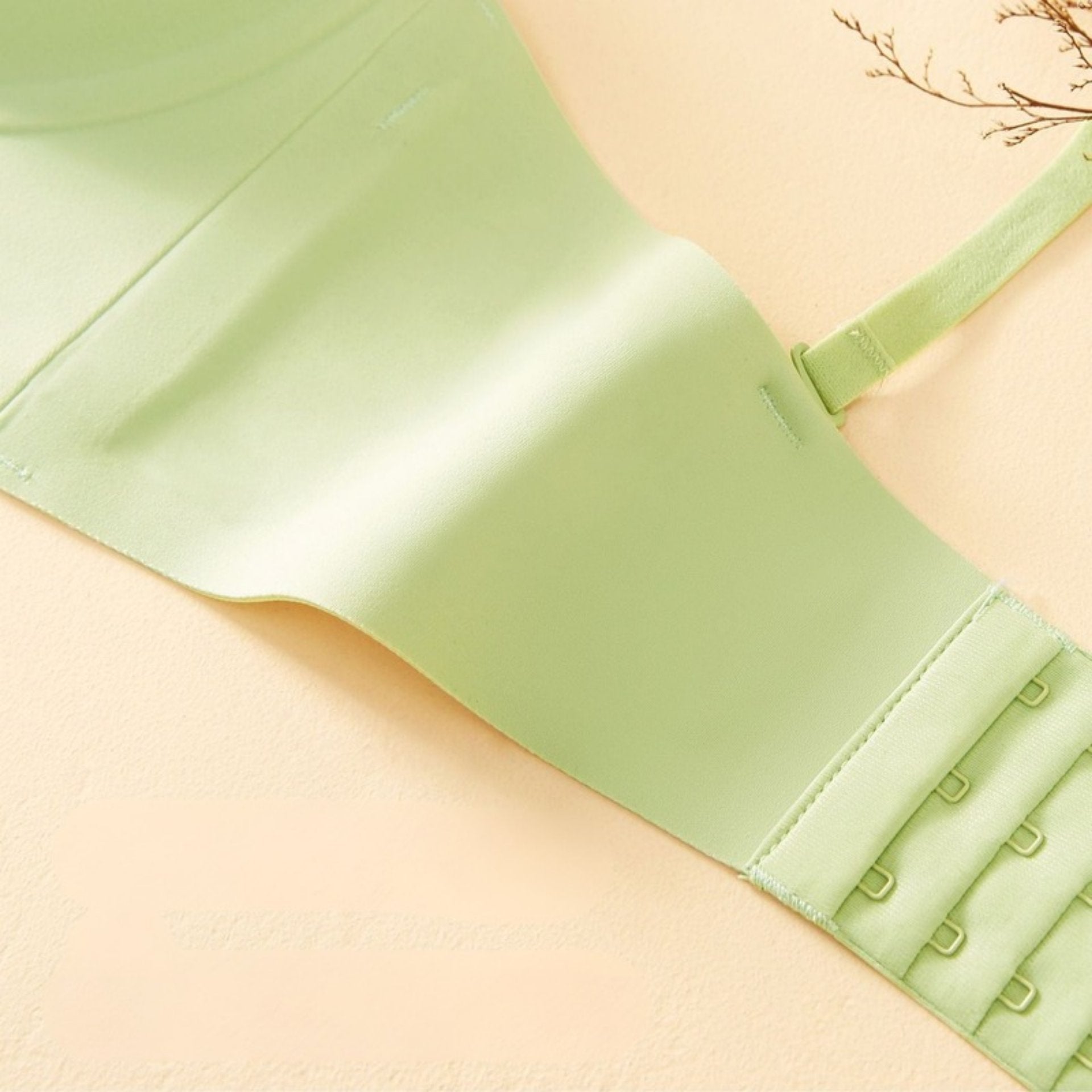 Close-up of a light green bra’s high-elastic, seamless side panel, offering smooth shaping and breathability.