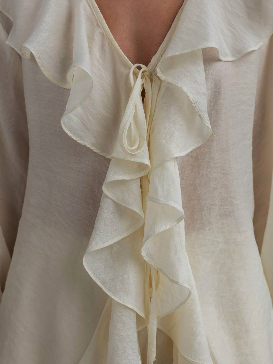 Close-up of a white blouse with ruffled details